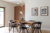Modern home with Dining Room, Table, Pendant Lighting, and Light Hardwood Floor. Natural textures and finishes create drama in this dining area, connecting to an indoor/outdoor living design. Casework finish: Natural Walnut by Semi-Handmade; Pendant: Cliff Suspension by Lambert Et Fils. Photo of Open and Airy Whole-Home Remodel