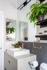 Modern home with Bath Room. Crisp neutrals in this modern bathroom are filled with visual texture and warmth. Vanity and Sink: Wetstyle; Faucetry: Purist by Kohler; Sconce: Stiletto by Sonneman; Shelves: West Elm; Wall Tile: Savoy Mosaic in Graphite by Ann Sacks. Photo 11 of Open and Airy Whole-Home Remodel