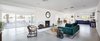 Modern home with Living Room, Gas Burning Fireplace, Coffee Tables, Sofa, Concrete Floor, Wood Burning Fireplace, Chair, End Tables, and Recessed Lighting. The homeowners wanted to create a very open pace, so they knocked out walls to create an open concept floor plan. Photo of This Palm Springs Gem Gets A Modern Makeover With A Bohemian Twist