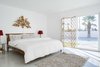 Modern home with Bedroom, Concrete Floor, and Recessed Lighting. Simple concrete floors adorn most of the house so that a less traditional design influence can be added with rugs and other decor. Photo 9 of This Palm Springs Gem Gets A Modern Makeover With A Bohemian Twist