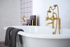 Modern home with Bath Room, Soaking Tub, Open Shower, Freestanding Tub, Concrete Floor, and Mosaic Tile Wall. Custom brass fixtures and a clawfoot tub give both a modern and classic feel. Photo 20 of This Palm Springs Gem Gets A Modern Makeover With A Bohemian Twist