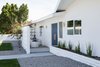 Modern light fixtures in a midcentury style meet more bohemian elements like an ocean blue door and spiritual meditation statue. Photo 15 of This Palm Springs Gem Gets A Modern Makeover With A Bohemian Twist modern home