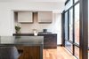 Modern home with Kitchen. All of the main spaces, sandwiched between the garage and utility room and street, are brought to life by the natural light provided by the a new four-story light-well. Photo 2 of Over-The-Rhine Urban Revival