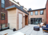 Modern home with Exterior and Wood Siding Material. Tiered terrace space creates multiple opportunities for outdoor experiences with a public and private separation. The upper floor contains children’s bedrooms, the master suite, outdoor fireplace and even a Japanese soaking tub- a true retreat nestled within the bustle of the city! Photo 16 of Over-The-Rhine Urban Revival