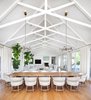 Modern home with Dining Room, Ceiling Lighting, and Table. “When in doubt, go with white” was a guiding design principle on this project by interior designer Eric Ford.Exposed wooden white beams create unique patterns in the open concept living and dining room, floating high above the table for twelve. Photo 4 of Light Filled House For Ten