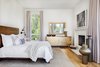 Modern home with Bedroom. They kept the master bedroom simple, yet inviting, with warm neutrals and rich textures, and a wood-burning fireplace. Photo 11 of Light Filled House For Ten