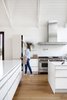 Modern home with Kitchen. Designer Eric Ford chose a Poggenpohl kitchen system with a laminate finish for its durability and minimalist style. Glazed Ann Sacks tiles add texture and visual interest. Photo 3 of Light Filled House For Ten