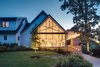 A literal floor to ceiling covering of glass covers the front entrance. Photo 14 of Light Filled House For Ten modern home