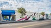 Modern home with Exterior, Curved RoofLine, and Stucco Siding Material. New building facade, featuring mural "El Sereno Happiness" courtesy of ManOne, artist. Photo of HATCHlabs @LA Bioscience HUB