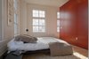 The 1,395 SF unit occupies the northeast corner of the third floor, with six over-sized windows framing a sweeping view of the East Liberty cathedral. The design objective was to create within the shell of the building an airy and elegant, informal yet luxurious living space. Photo of Y Lofts modern home