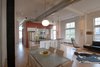 The larger, functional cube contains the kitchen, laundry room and master bath. The smaller cube—more of a partition—houses audiovisual equipment for the living area and open shelving in the office. Photo 3 of Y Lofts modern home