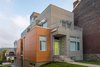 The massing of the Ligonier Street Residence largely consists of a narrow, articulated rectangular volume that is bisected by a custom central staircase that links all four levels of the 3,557 square foot home. The natural sloping topography of the site allows for access to the home at the lower basement level from an alley condition at the downhill property edge and at the first floor from the public street at the uphill property edge. Photo of Ligonier Street Residence modern home
