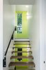 The massing of the residence largely consists of a narrow, articulated rectangular volume that is bisected by a custom central staircase that links all four levels of the home. Photo 9 of Ligonier Street Residence modern home