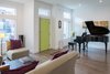 The first floor features a public entry from the street, leading to a formal living room with an alcove for the couple’s baby grand piano. Photo 8 of Ligonier Street Residence modern home