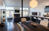 A large, open plan great room containing the kitchen, dining, and family room functions are located at the northwest portion of the floor plan, allowing for views of downtown Pittsburgh. Photo 10 of Ligonier Street Residence modern home