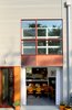 The two-story space opens out to a semi-private patio through a large overhead glass garage door opening that emphasizes an indoor/outdoor living space. Photo 6 of Lola House modern home