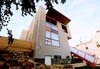 Sustainable design elements include recycled/salvaged items such as the red steel entry stair and mahogany front door. Each of these features is rebuilt from reclaimed items from other structures. Photo 7 of Lola House modern home