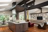 Opening up the kitchen walls required structural work that we embraced, making it a focal point of the home's design. These details were also carried through to new covered deck and entry. Photo 2 of The Ping Pong Home modern home