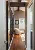 This view to the master bedroom shows the inclusion of the same beam details used elsewhere in the home. Photo 8 of The Ping Pong Home modern home