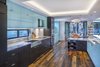 The kitchen utilizes induction rather than traditional gas... contributing to the house's 5 star green build. Photo 7 of Collier Residence modern home