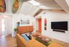 Exposed wood beams of the original home from 1957 + Vintage Burton Performer snowboard c. '84 Photo 9 of The Beach Lab modern home