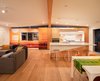 Modern home with Kitchen, Medium Hardwood Floor, Ceramic Tile Backsplashe, Track Lighting, Engineered Quartz Counter, Wall Oven, Refrigerator, Undermount Sink, White Cabinet, Open Cabinet, Pendant Lighting, Wood Cabinet, and Ceiling Lighting. Sunset Photo mural shot by Grant Ellis, Photo Editor of Surfer Magazine, is actually installed on the Fisher Paykel built in fridge. Custom made bar stool by www.raelmade.com Photo 7 of Cardiff with A Side of Ranch