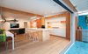 Modern home with Kitchen, Wood Cabinet, Wall Oven, Engineered Quartz Counter, Open Cabinet, Range Hood, Medium Hardwood Floor, Ceiling Lighting, Ceramic Tile Backsplashe, Pendant Lighting, Undermount Sink, Refrigerator, Cooktops, and White Cabinet. White kitchen cabinetry and walls allow the natural wood tones to speak for themselves. Geomteric metal bases with solid Douglas Fir seats by www.raelmade.com Photo 9 of Cardiff with A Side of Ranch