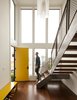 Modern home with Staircase, Wood Tread, and Metal Railing. view of the window wall and stair in the double-height front entry, custom light by Larissa Sands Photo 8 of Glen Park House