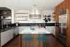 Modern home with Kitchen, Refrigerator, Dishwasher, Cooktops, Range, Range Hood, Marble Counter, Pendant Lighting, Wood Cabinet, Laminate Cabinet, Medium Hardwood Floor, Ceramic Tile Backsplashe, and Undermount Sink. new kitchen from Henrybuilt with paperstone & calacatta counters Photo of Glen Park House