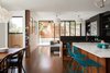 Modern home with Kitchen, Marble Counter, Wood Cabinet, Medium Hardwood Floor, Pendant Lighting, and Undermount Sink. view of the open kitchen, dining and living areas Photo 10 of Glen Park House