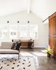 Modern home with Living Room, Concrete Floor, Wall Lighting, Chair, Media Cabinet, Storage, and Bookcase. family room with barn door Photo 3 of Wild Way Remodel
