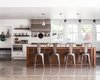 Modern home with Kitchen, Microwave, Range, Range Hood, Quartzite Counter, Wood Cabinet, White Cabinet, Concrete Floor, Porcelain Tile Floor, Ceramic Tile Backsplashe, Pendant Lighting, and Undermount Sink. kitchen walnut island with stools Photo 6 of Wild Way Remodel