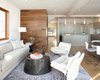 Modern home with Living Room, Chair, Light Hardwood Floor, Sofa, and Accent Lighting. walnut wall cladding quantum windows Photo 3 of Bungalow Update