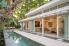Each interior space is contained within floor-to-ceiling glass, opening out to exterior spaces that continue the home's living area. The line between indoor and outdoor is blurred throughout the home, yielding a space that is greater than its parts. Photo 2 of The Pavilion House modern home