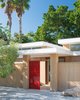 The main entrance of the Pavilion House welcomes guests into the interior courtyard, and then to a second set of doors that enter the main home. Photo 7 of The Pavilion House modern home