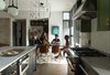 Modern home with Kitchen, Concrete Counter, Marble Counter, Dark Hardwood Floor, Subway Tile Backsplashe, Concrete Backsplashe, Wood Cabinet, Pendant Lighting, Ceiling Lighting, Range, and Range Hood. Architect Tobin Green and his wife, Bianca, entertain regularly at 400SOLA. It's an important part of their lifestyle, and thus, an important part of Green's design. Photo 10 of 400SOLA
