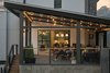 Modern home with Outdoor, Back Yard, Metal Fences, Wall, Large Patio, Porch, Deck, and Hanging Lighting. A dramatic second-level patio provides step-out access for outdoor entertaining. Its perch provides privacy and a relaxing view of the historic neighborhood around it. Photo of 400SOLA
