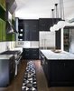 Modern home with Kitchen, Concrete Counter, Wood Cabinet, Marble Counter, Dark Hardwood Floor, Subway Tile Backsplashe, Pendant Lighting, Refrigerator, Range, Concrete Backsplashe, Ceiling Lighting, and Range Hood. Despite the moody appeal of the kitchen, filtered light fills much of the space from floor-to-ceiling windows and a tall, narrow frame above the sink. Photo 11 of 400SOLA