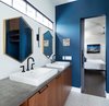 Modern home with Bath Room, Concrete Counter, Wall Lighting, and Ceramic Tile Floor. Bold colors, geometric design elements and warm woods give grand appeal to the home's private spaces. Here, the master bathroom is bright and bold, but relaxed and functional. Photo 12 of 400SOLA