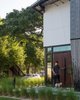 Modern home with Outdoor, Front Yard, Grass, Shrubs, and Trees. Each detail in the home was treated as an opportunity for expression. Here, a tall, weathered-steel door pivots smoothly with a tug on its leather-bound handle. Photo 2 of 400SOLA