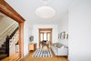 Modern home with Living Room, Sofa, Pendant Lighting, Console Tables, Medium Hardwood Floor, Light Hardwood Floor, and Accent Lighting. Parlour level Living Room: restored existing woodwork bringing it back to life Photo 4 of Brooklyn Brownstone
