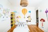 Modern home with Kids Room, Bed, Storage, Shelves, Medium Hardwood Floor, Bedroom Room Type, Toddler Age, and Neutral Gender. Children's bedroom: playful fabric decals enliven a historic room Photo 9 of Brooklyn Brownstone
