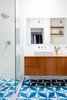 Modern home with Bath Room, Wood Counter, Vessel Sink, Concrete Floor, Enclosed Shower, Open Shower, Full Shower, Recessed Lighting, Subway Tile Wall, Pendant Lighting, Concrete Wall, Accent Lighting, Mosaic Tile Wall, and One Piece Toilet. Masterbathroom: custom teak vanity floats above a graphic cement tile floor Photo 10 of Brooklyn Brownstone