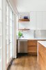 Modern home with Kitchen, Glass Tile Backsplashe, Wood Cabinet, Ceiling Lighting, Quartzite Counter, Dark Hardwood Floor, Dishwasher, Pendant Lighting, White Cabinet, Recessed Lighting, Undermount Sink, and Medium Hardwood Floor. Figured walnut grain of the basecabinets Photo 6 of Tennis House