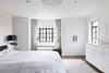 Modern home with Bedroom, Storage, Night Stands, Wardrobe, Bed, Dresser, Bench, Bookcase, Ceiling Lighting, Medium Hardwood Floor, Dark Hardwood Floor, Pendant Lighting, and Recessed Lighting. Masterbedroom with silk accent wallcovering balanced with neutral white walls and silk curtains Photo 8 of Tennis House