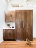 Modern home with Kitchen, Porcelain Tile Backsplashe, Medium Hardwood Floor, Refrigerator, Ceramic Tile Backsplashe, Wood Cabinet, and Light Hardwood Floor. The fridge is concealed behind grain-matched walnut doors (and a very cute dog). Photo 3 of Boulder Kitchen