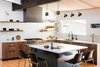 Modern home with Kitchen, Medium Hardwood Floor, Range, Colorful Cabinet, Light Hardwood Floor, Range Hood, Pendant Lighting, Undermount Sink, Ceramic Tile Backsplashe, Wood Counter, Porcelain Tile Backsplashe, and Wood Cabinet. The Cabinet Face's DIY paint-grade flat panel doors and custom panels are installed in the island.
Photo of Boulder Kitchen