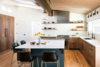 Modern home with Kitchen, Porcelain Tile Backsplashe, Range, Range Hood, Light Hardwood Floor, Wood Cabinet, Undermount Sink, Refrigerator, Pendant Lighting, Ceramic Tile Backsplashe, Colorful Cabinet, and Medium Hardwood Floor. The walnut flat panel cabinet fronts add warmth to this kitchen in Boulder, CO. Photo 2 of Boulder Kitchen