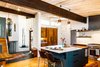 Modern home with Kitchen, Ceramic Tile Backsplashe, Refrigerator, Range Hood, Pendant Lighting, Wood Cabinet, Colorful Cabinet, Ceiling Lighting, Porcelain Tile Backsplashe, Light Hardwood Floor, and Range. As seen in Boulder Lifestyle Magazine. Photo 4 of Boulder Kitchen