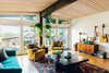 Modern home with Living Room, Light Hardwood Floor, Ottomans, Console Tables, Chair, Sofa, Floor Lighting, and Coffee Tables. As seen in Boulder Lifestyle Magazine Photo 8 of Boulder Kitchen